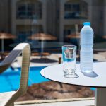 Bottle Of Water And Glass On Table At The Terrace In Hotel Again